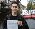 Aaron with Driving test pass certificate